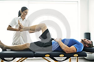 Physiotherapist doing treatment with patient in bright office