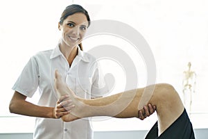 Physiotherapist doing treatment with patient in bright office