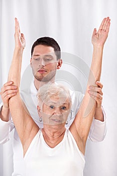 Physiotherapist and elderly woman during rehabilitation