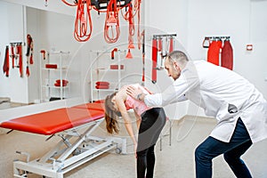 Physiotherapist examining girl`s back in the hospital