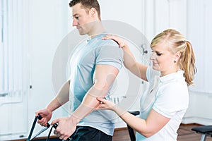 Physiotherapist excercising patient in practice
