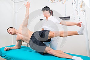 Physiotherapist exercising with patient in practice