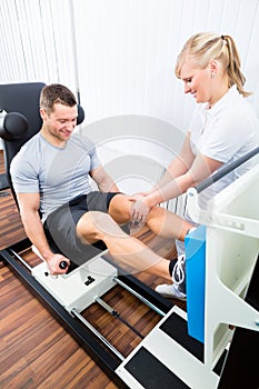 Physiotherapist exercising patient in sport therapy