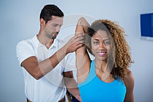 Physiotherapist giving arm massage to female patient
