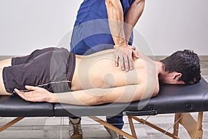 Physiotherapist giving a back massage. Chiropractic, osteopathy, manual therapy, acupressure