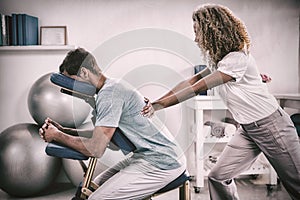 Physiotherapist giving back massage to a patient