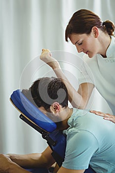 Physiotherapist giving back massage to a patient