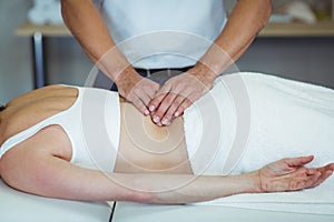 Physiotherapist giving back massage to a woman