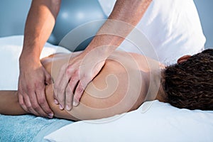 Physiotherapist giving hand massage to a woman