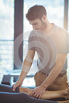 Physiotherapist giving knee therapy to a woman