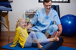 Physiotherapist giving physical therapy to the girl