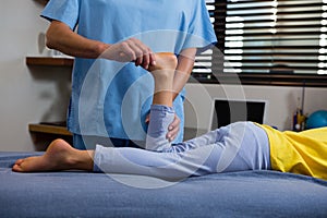 Physiotherapist giving physical therapy to the girl