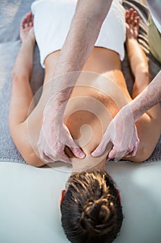Physiotherapist giving physical therapy to the neck of a female patient