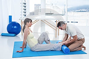 Physiotherapist giving physiotherapy to pregnant woman photo