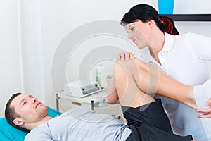 Physiotherapist medicate patient in practice