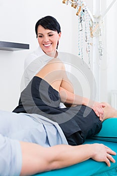 Physiotherapist medicate patient in practice