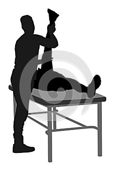 Physiotherapist and patient exercising in rehabilitation center,  silhouette. Doctor supports sportsman during physiotherapy