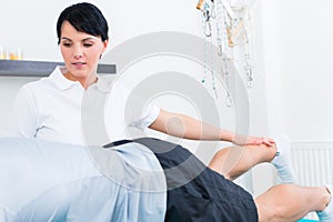 Physiotherapist with patient in practice