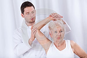 Physiotherapist rehabilitating elderly woman