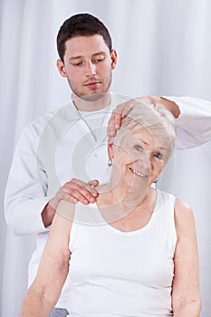 Physiotherapist rehabilitating woman photo