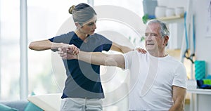 Physiotherapist, senior man and stretching arm, healing arthritis or assessment of muscle rehabilitation, joint pain or