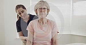 Physiotherapist, senior patient and medicine ball exercise for rehabilitation and physical therapy. Elderly woman with a
