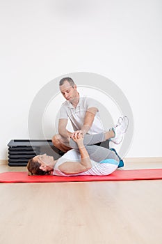Physiotherapist showing woman an exercise