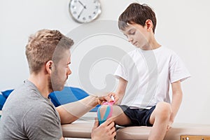 Physiotherapist taping a child