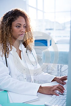 Physiotherapist working on computer