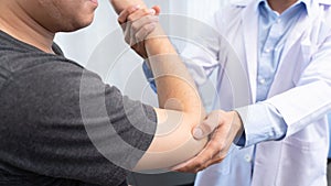 Physiotherapist working concept, Doctor and patient suffering or Chiropractor examining from shoulder or elbow pain in clinic
