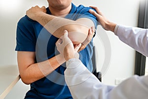 Physiotherapist working concept, Doctor and patient suffering or Chiropractor examining from shoulder pain in clinic medical photo