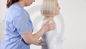 Physiotherapist working with middle aged patient in clinic