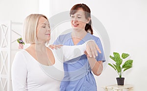 Physiotherapist working with middle aged patient in clinic