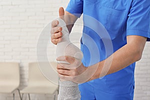 Physiotherapist working with patient in clinic, closeup.