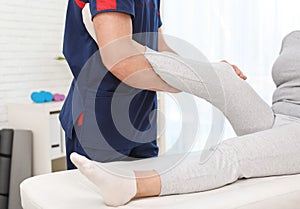 Physiotherapist working with patient in clinic, closeup