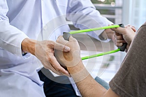 Physiotherapist working with patient doing with exercise, physical therapy concept