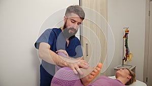 Physiotherapy rehabilitation, manipulation of patient s knee. Physiotherapist