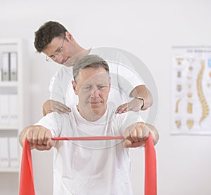 Physiotherapy: Senior man and physiotherapist photo