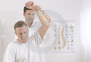 Physiotherapy: Senior man and physiotherapist photo