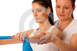 Physiotherapy - therapist doing arm strenghteninh excercises wit