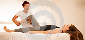 Physiotherapy -therapist exercising with patient , working on le