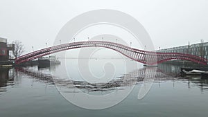 Phytonbrug or Hoge Brug in Amsterdam fly underneath of a foggy grey winter day red art architecture