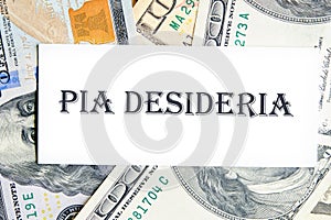 PIA DESIDERIAPIA the phrase in Latin means Good intentions on a white business card against the background of money, a business