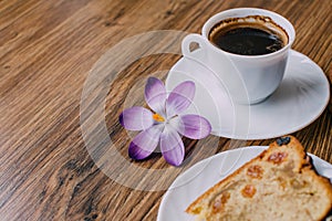 Piace of cake with flowers around and coffee photo