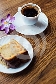 Piace of cake with flowers around and coffee photo