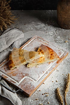 Piace of cakes on wooden board and gray background photo