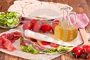 Piadina with ham and lettuce.