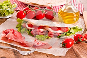 Piadina with ham and lettuce.