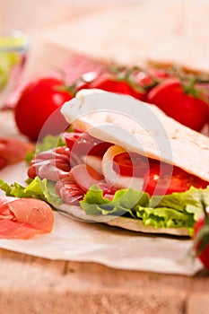 Piadina with ham and lettuce.