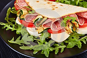Piadina with mozzarella, tomato, salami, zucchini